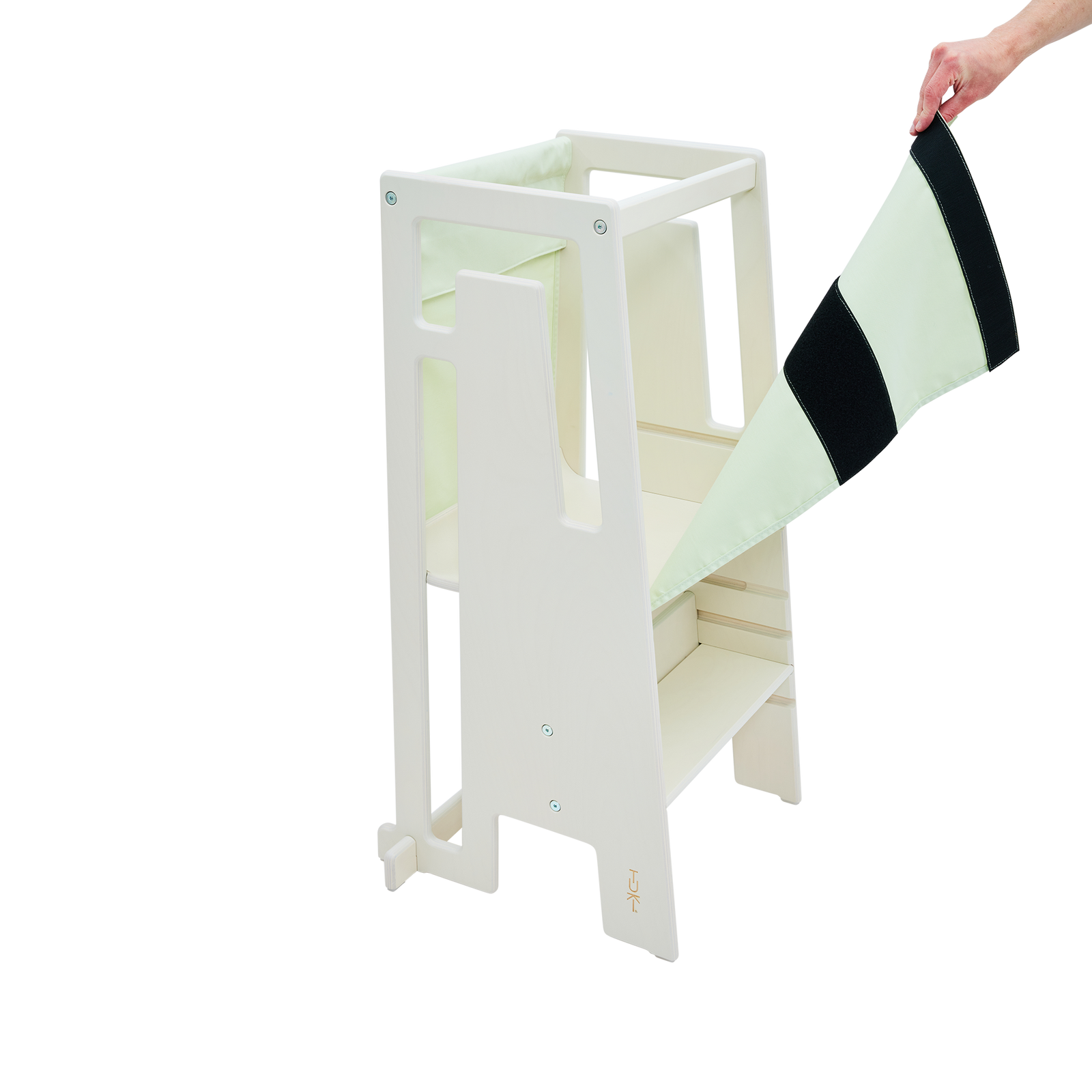 Child stands safely in the Tuki Learning Tower with Starter Cloth